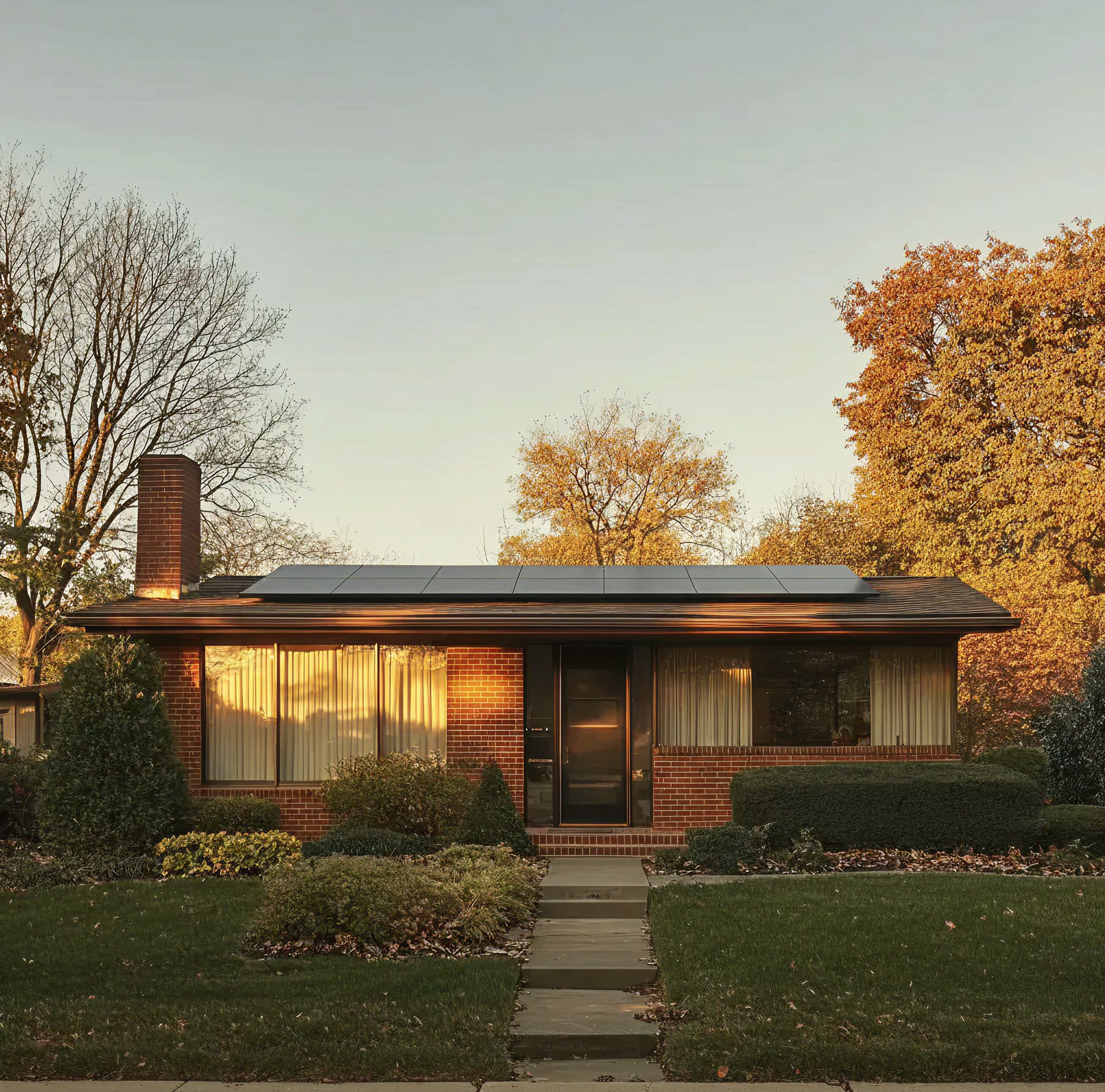 A family home at sunrise with solar panels on the roof